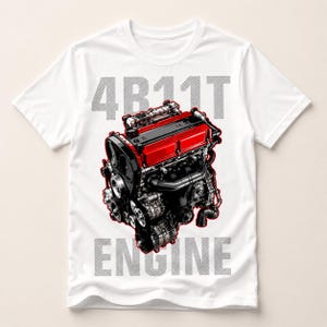 May include: A white short-sleeve t-shirt featuring a detailed graphic of a 4B11T engine with a prominent red valve cover and black mechanical components. The text 4B11T is printed above the engine graphic and the word ENGINE is printed below it.