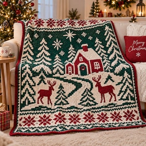 May include: A rectangular crochet blanket featuring a winter landscape with a red house, two red deer, and green pine trees against a dark green background. The design includes white snowflakes and a red and white snowflake border pattern.