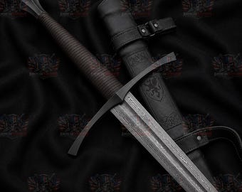May include: A longsword with a dark, textured grip and a straight crossguard, featuring a blade with a visible layered pattern. The sword is accompanied by a black leather scabbard embossed with a lion emblem and decorative heart-shaped details.