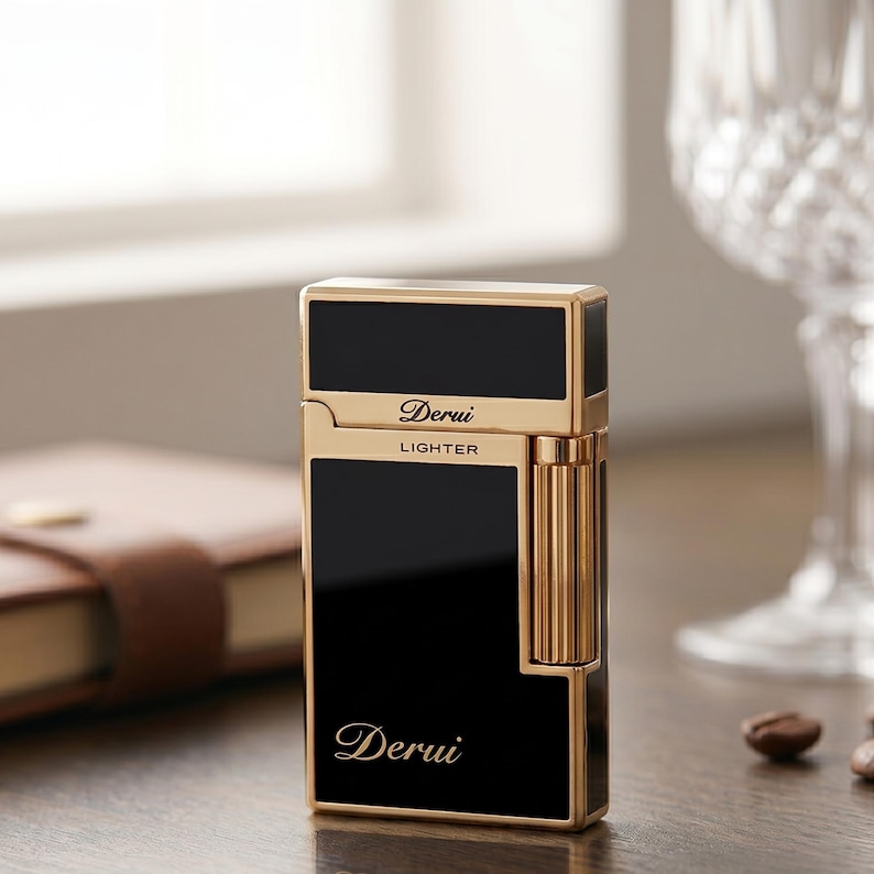 May include: A rectangular lighter with a polished gold-tone metal frame and glossy black panels. The front features the text Derui in a script font and the word LIGHTER in block letters. A vertical ribbed gold cylinder is attached to the side.