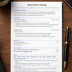 May include: A professional resume for Albert Saxe-Coburg, a full-stack software engineer. The document includes sections for professional summary, experience, education, certifications, skills, and volunteer work, alongside a black and gold pen.