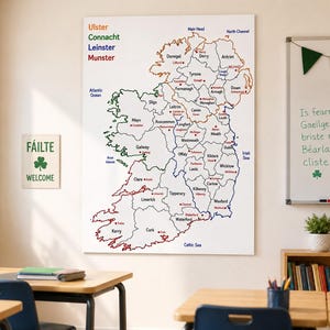 May include: A large wall map of Ireland featuring the four provinces of Ulster, Connacht, Leinster, and Munster color-coded in orange, green, blue, and red. The map displays county names, major towns, and surrounding bodies of water in black text.