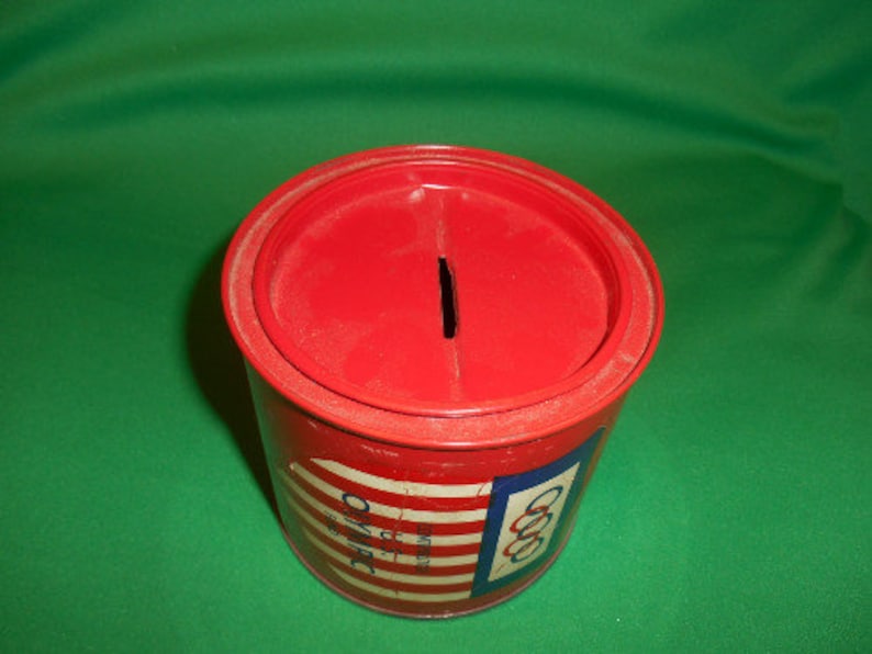 1 Circa 1960/'s. One US Olympic Fund Bank Pressed Steel