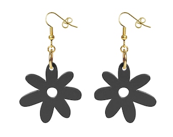 May include: A pair of black flower-shaped earrings with gold hooks and a small gold ring at the top of each earring.