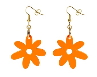 May include: A pair of bright orange flower-shaped earrings. Each earring features a gold-colored fish hook and a small gold ring connecting to the orange flower. The flowers have a circular hole in the center.
