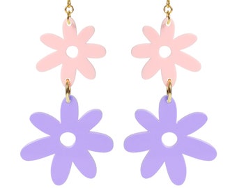May include: A pair of dangle earrings with two flower charms. The top flower is pink and the bottom flower is purple.