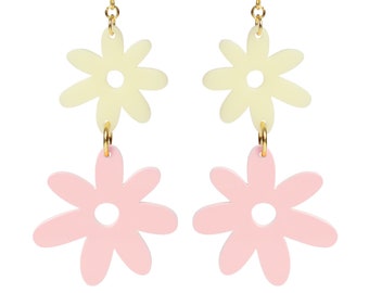 May include: A pair of gold dangle earrings with two flower charms. The top flower charm is yellow and the bottom flower charm is pink.