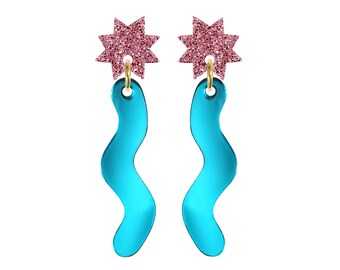 May include: A pair of dangle earrings with a pink glitter star charm and a turquoise blue wavy shape.