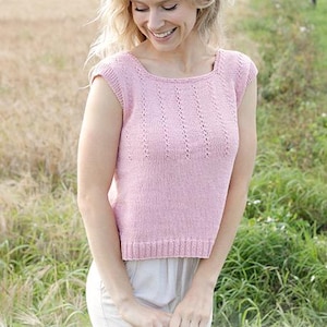 May include: A light pink knitted top with a square neckline and cap sleeves. The top features vertical textured detailing and a ribbed hem. The image includes the text "DROPS DESIGN" and the website address www.garnstudio.com.