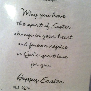 May include: White card with the message "May you have the spirit of Easter always in your heart and forever rejoice in God's great love for you." and "Happy Easter" in elegant script.