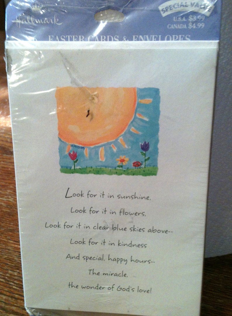May include: Hallmark Easter cards and envelopes in a clear plastic package. The card features a watercolor illustration of a sun, blue sky, and flowers. Text on the card reads: "Look for it in sunshine..." and more.