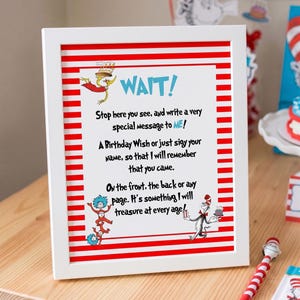 Op de afbeelding: Een wit ingelijst bord met horizontale rode en witte strepen en Dr. Seuss-figuren. De tekst luidt: WAIT! Stop here you see, and write a very special message to ME! A Birthday Wish or just sign your name, so that I will remember that you came. On the front, the back or any page. It's something I will treasure at every age!
