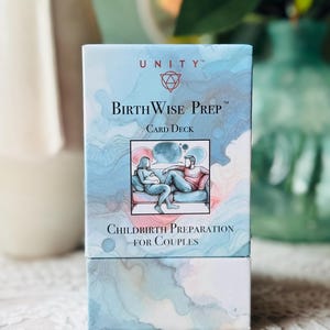 May include: A rectangular card deck box titled BirthWise Prep featuring a watercolor-style blue and pink abstract background. The front displays a central illustration of two people sitting on a couch with speech bubbles and the text Childbirth Preparation for Couples.