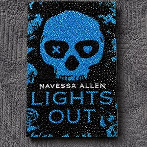 May include: A rectangular book cover titled Lights Out by Navessa Allen, featuring a central blue skull design composed of small rhinestones. The skull has an X and a heart in the eye sockets, set against a black background with blue accents.