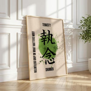 May include: A rectangular framed wall art print featuring a beige background with a subtle geometric pattern. A large green paint splatter sits in the center behind bold black Japanese kanji characters, with the text TENACITY, SHUNNEN, and RELENTLESS GRIP ON WHAT MATTERS MOST.