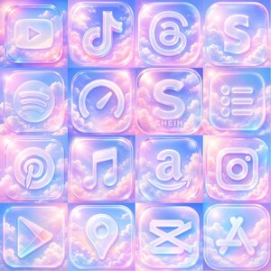 May include: A grid of sixteen square app icons featuring translucent, glass-like symbols set against a vibrant pink and blue sky with fluffy clouds. The icons include logos for YouTube, TikTok, Threads, Spotify, Shein, Pinterest, Apple Music, Amazon, Instagram, and the App Store.