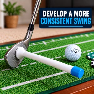 May include: A silver golf club iron is positioned against a white training aid with a blue end cap. A white Callaway golf ball sits on a green putting mat with white markings. A blue sign with white text reads DEVELOP A MORE CONSISTENT SWING.