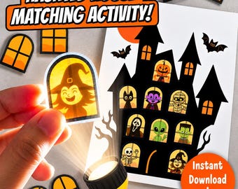 Op de afbeelding: Een Haunted House Matching Activity set met een zwart silhouet van een huis en ramen met stripfiguren zoals een pompoen, vampier, mummie, alien en skelet, inclusief oranje raamuitsparingen en een zaklamp.