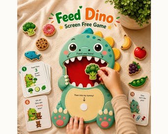 Op de afbeelding: Een groen dinosaurusvormig spelbord met een wijd open mond en een gele buik, voorzien van de tekst Feed Dino Screen Free Game, Feed me here en Then into my tummy. Inclusief diverse voedselvormige fiches en instructieve spelkaarten.