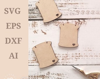 May include: Three unfinished wooden spool shapes with a small heart cutout on each. The spools are on a white wooden surface with a pair of gold scissors.