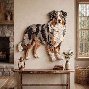 May include: A layered wooden wall art piece depicting an Australian Shepherd dog with a tri-color coat of black, gray, white, and tan. The dog is shown in a standing profile, featuring intricate carved details that create a textured fur effect.