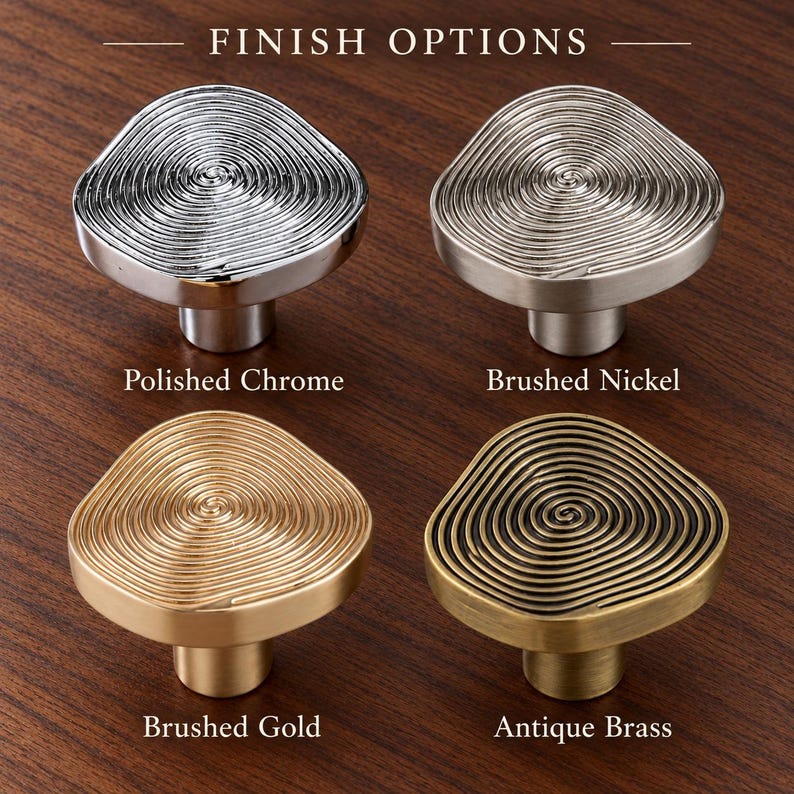 May include: Four cabinet knobs labelled FINISH OPTIONS. The top left is polished chrome, top right is brushed nickel, bottom left is brushed gold, and bottom right is antique brass. Each knob has a circular, spiralling, raised texture.