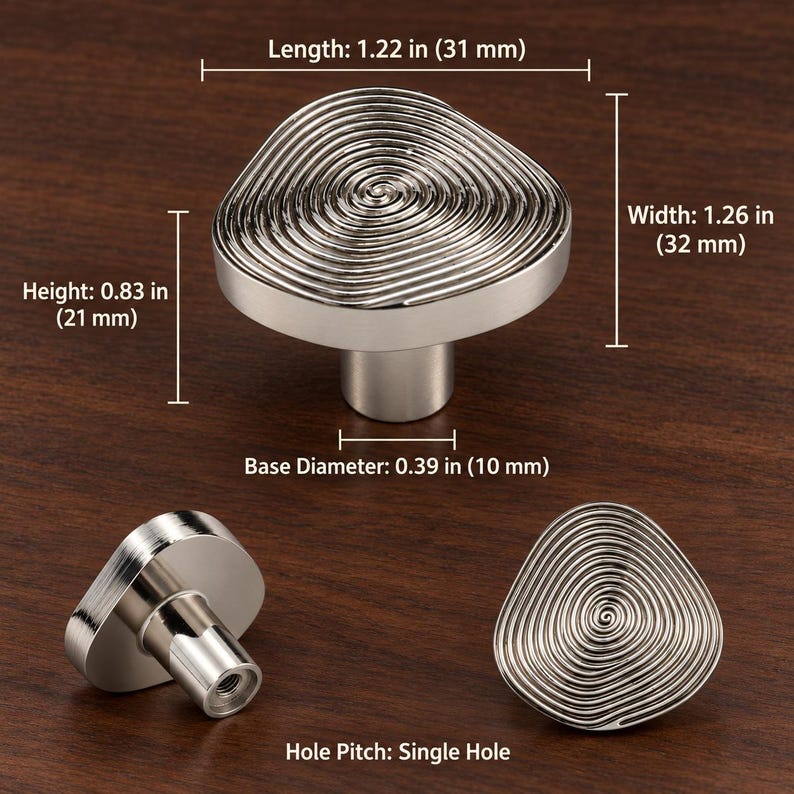 May include: A silver-toned cabinet knob with a spiral pattern on its top surface. The knob has a length of 31 mm, a width of 32 mm, a height of 21 mm, and a base diameter of 10 mm. It features a single hole pitch for mounting purposes.