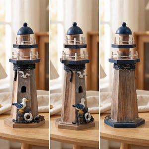 May include: A decorative wooden lighthouse figurine featuring a dark blue dome top, two railed balconies, and a rope accent. The structure is adorned with a small white seagull figure, a larger seagull perched on a post, and a white life preserver.
