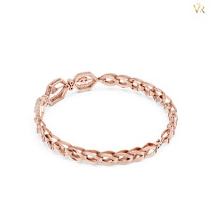 May include: A rose gold bracelet featuring a continuous braided or woven metal link design. The circular band is composed of repeating interlocking oval-shaped segments, creating a textured, openwork pattern throughout the entire piece of jewelry.