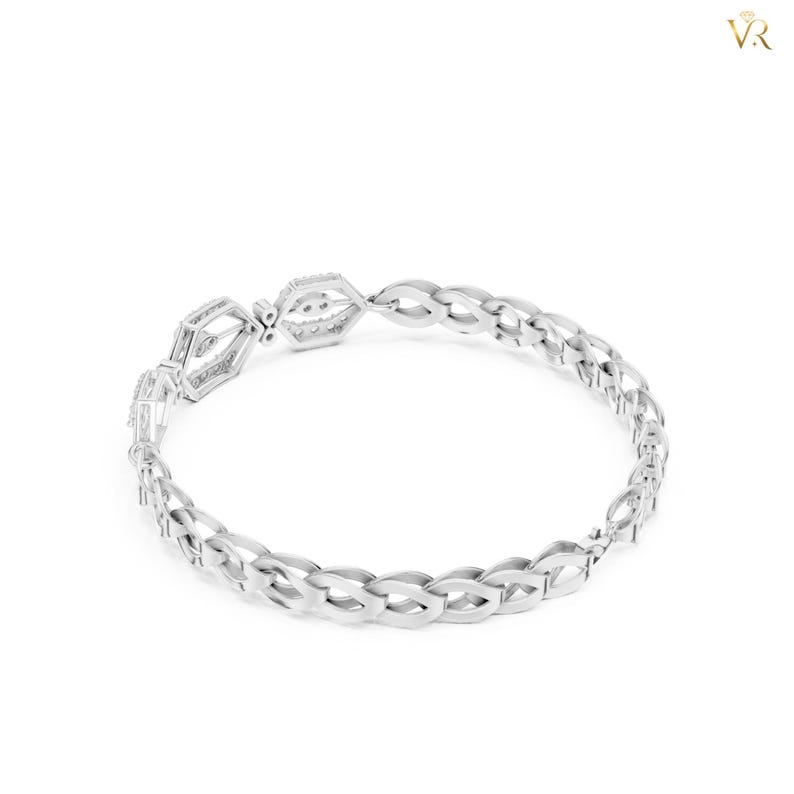 May include: A silver-toned bracelet featuring a series of interconnected, oval-shaped links. The design includes a central section with two distinct, geometric, open-work rectangular components that serve as a focal point for the piece.