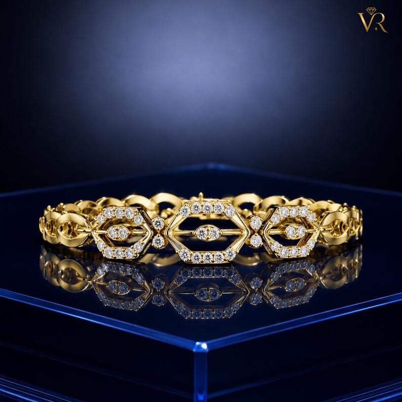 May include: A gold link bracelet featuring a series of repeating hexagonal motifs. Each hexagon is outlined with small, clear, round-cut stones, and a central horizontal bar within each hexagon is also set with small, clear, round-cut stones.