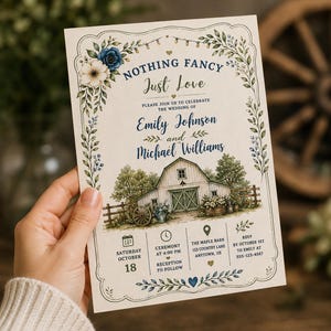 May include: A wedding invitation card featuring a rustic barn illustration, blue and white floral borders, and the text: Nothing Fancy Just Love, Emily Johnson and Michael Williams, Saturday October 18, The Maple Barn, 123 Country Lane, Anytown, US.