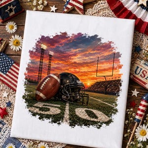 May include: A rectangular canvas print featuring a football and a helmet resting on a grass field at the 50-yard line. The background shows a stadium at sunset with bright stadium lights, a goalpost, and a vibrant orange and purple sky.