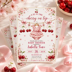 May include: A rectangular baby shower invitation card featuring a pink ruffled romper hanging on a clothesline with cherries and cherry blossoms. The text reads: She is the cherry on top, Please join us for a baby shower honoring Isabella Grace, August 26, 2:00 PM, The Orchard Cafe, 75656 Cristo Rey Dr., Cupertino, CA 26625, RSVP to Isabella at 487-135-5633.
