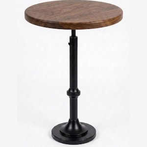 May include: A round side table featuring a dark brown wood grain top and a black metal pedestal base. The central column has a visible adjustment mechanism with a small lever, supported by a circular black metal base plate at the bottom.
