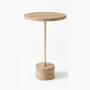 May include: A side table featuring a circular light brown wood grain tabletop supported by a slender vertical brass-coloured metal rod connected to a cylindrical light brown wood grain base that rests on the floor for stability and balance.