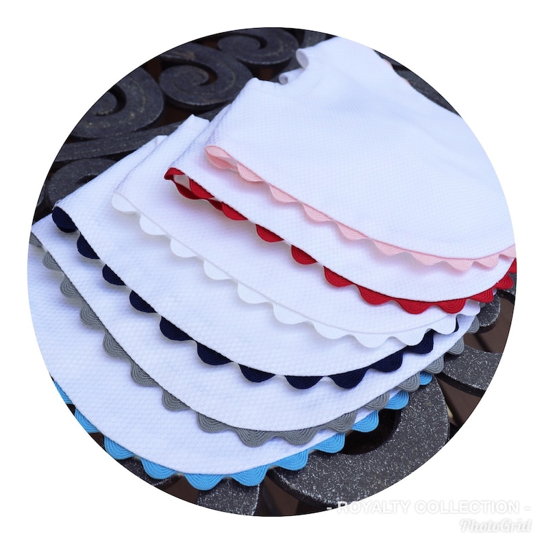 May include: Five white fabric collars with scalloped edges in different colors: pink, red, navy blue, gray, and light blue.