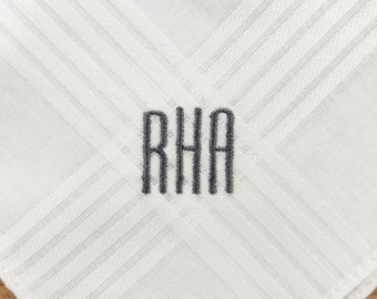 May include: White cotton handkerchief with a gray embroidered monogram "RHA" in the center.