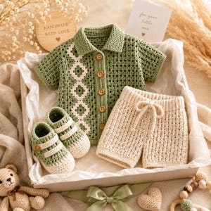 May include: A sage green crochet short-sleeve collared shirt with a vertical white floral pattern, five brown buttons, and matching sage green and white crochet booties, paired with cream-colored crochet shorts featuring a drawstring waist.