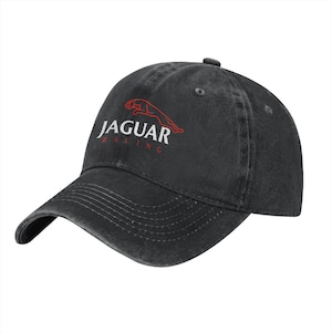May include: A black baseball cap with a distressed finish featuring the red outline of a leaping jaguar above the white text JAGUAR and the red text RACING embroidered on the front panel. The cap has a curved brim and stitched eyelets.