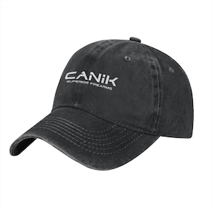 May include: A black baseball cap with a distressed, washed-out finish. The front features the white text CANIK and the words SUPERIOR FIREARMS printed directly below the brand name. The cap has a curved brim with visible stitching detail.
