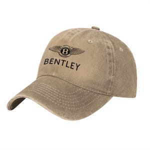 May include: A tan baseball cap with a distressed, washed-out finish. The front panel features the black Bentley logo, consisting of a winged emblem with a central letter B, and the word BENTLEY printed in black capital letters below the emblem.