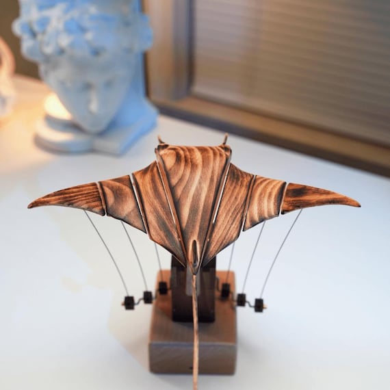 A hand-carved wooden manta ray that actually moves — mechanical automaton craft at its most hypnotic and desk-worthy.