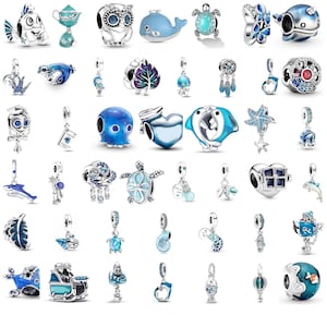May include: A collection of silver and blue-toned metal charms featuring various aquatic, animal, and whimsical designs. The assortment includes shapes like fish, turtles, owls, hearts, and sea creatures, many accented with blue enamel and sparkling stones.