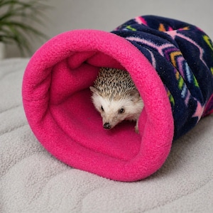 Give your small pets the cozy hideaway they deserve with this Guinea Pig Tunnel Bed, designed for comfort, play, and stress-free snuggling. This soft tunnel creates the perfect safe space. This washable small animal hideout is ideal for guinea pigs, hedgehogs, ferrets, chinchillas, and other small pets.
Features reinforced, structured openings on both ends to help it stay open, making it easy for your pets to enter, exit, and explore. It’s perfect for playtime or nap time.
