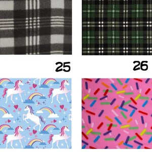 May include: Four fabric swatches with different patterns. Top left: black and white plaid. Top right: green and black plaid. Bottom left: light blue background with unicorns, rainbows, and hearts. Bottom right: pink background with colorful sprinkles.