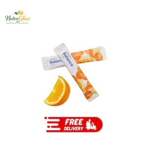 May include: Two white Unicity Balance Orange dietary supplement stick packs featuring a geometric orange circle pattern and text stating a net weight of 0.25 ounces (7.25 grams) per pack, accompanied by a single fresh orange wedge slice.