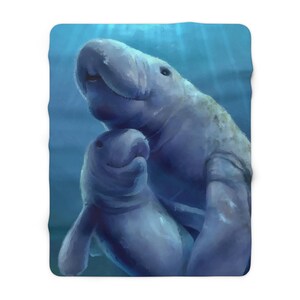 May include: A rectangular fleece blanket featuring a digital illustration of a large adult manatee swimming alongside a smaller calf in deep blue water. The artwork captures the gentle grey-toned marine mammals with soft lighting from above.