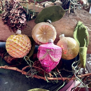 May include: A white ceramic mug with a black handle and the text "But First, Coffee" in a handwritten style. The mug is on a white surface. The mug is approximately 4 inches tall.