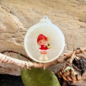 May include: A set of three ceramic mugs with a speckled, matte finish. The mugs are in shades of cream, light gray, and dark gray. Each mug has a simple, minimalist design and a rounded handle. The mugs are likely for coffee or tea.